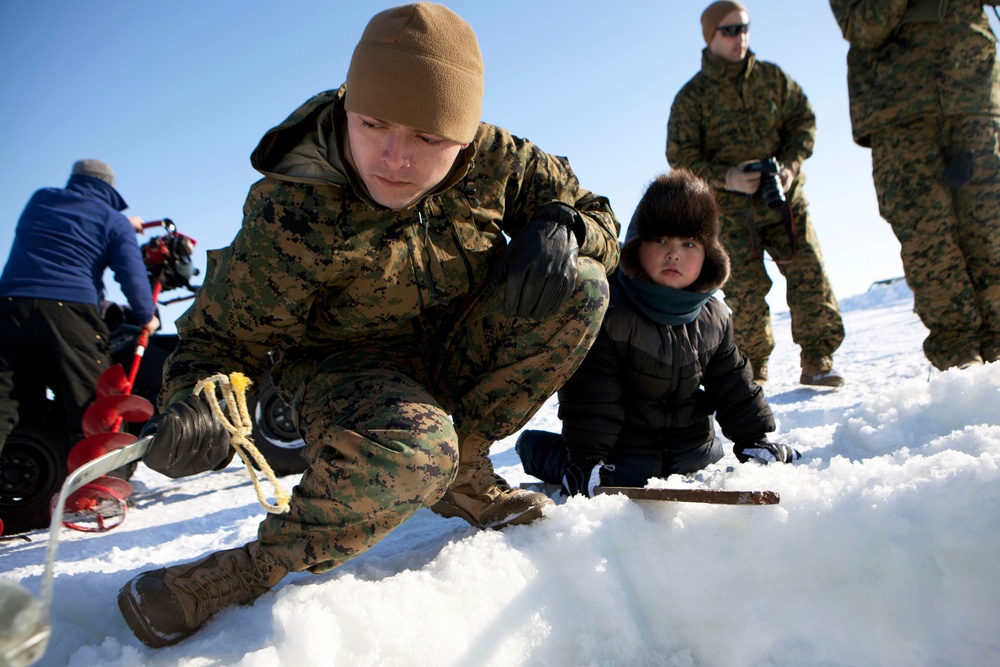 Marines ice fish with Alaskan natives
