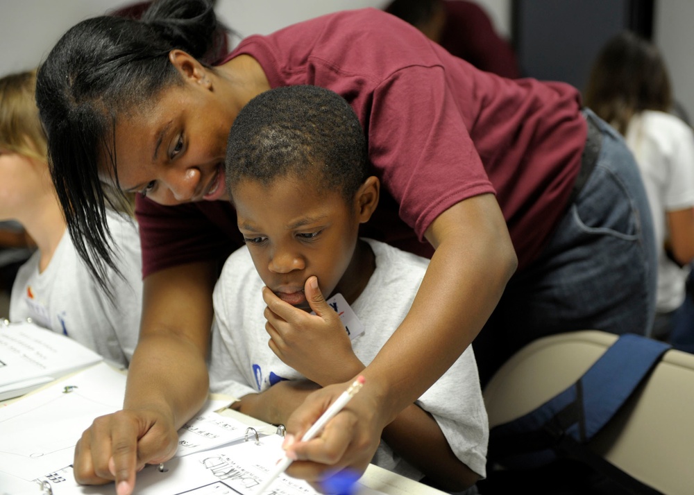 Sailor helps student during lesson