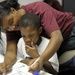 Sailor helps student during lesson