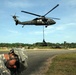 Troops endure strong winds during sling load training in Panama