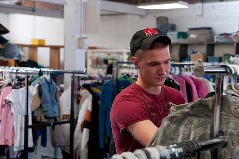 Senior airman looks through rack of ABUs