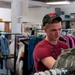 Senior airman looks through rack of ABUs