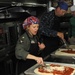 Officers prepare pizza