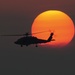HH-60H Sea Hawk flies at sunset
