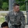 Region 3 Best Warrior Competition Two U.S. Army soldiers in ACU (Army Combat Uniform) digital camouflage are visible at what appears to be a training facility or obstacle course. The soldier in the background is identified by his name tape as 'LACROSSE' and wears a U.S. Army tape, an American flag patch, and what appears to be an Airborne or similar unit patch on his left shoulder. Both soldiers appear to be equipped with rappelling or climbing harness gear.