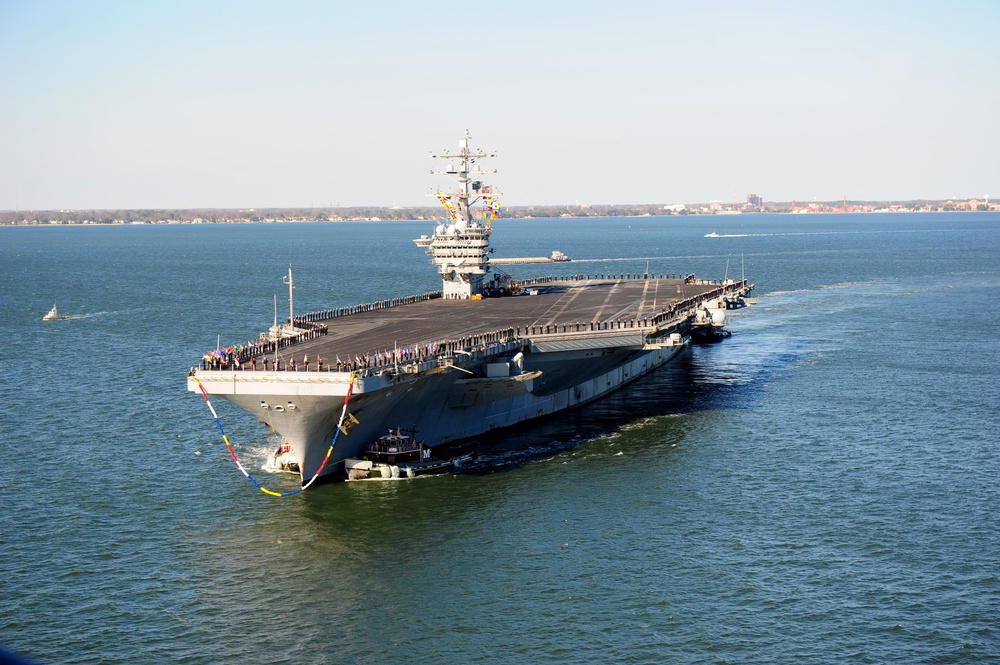 The aircraft carrier USS Dwight D. Eisenhower (CVN 69) makes its approach pierside at Naval Station Norfolk after a six-month deployment to the U.S. 5th and 6th Fleet areas of responsibility in support of Operation Enduring Freedom, maritime security oper