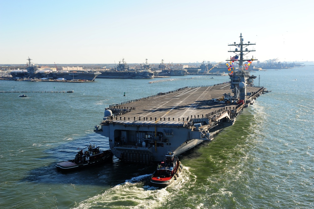 The aircraft carrier USS Dwight D. Eisenhower (CVN 69) makes its approach pierside at Naval Station Norfolk after a six-month deployment to the U.S. 5th and 6th Fleet areas of responsibility in support of Operation Enduring Freedom, maritime security oper