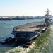 The aircraft carrier USS Dwight D. Eisenhower (CVN 69) makes its approach pierside at Naval Station Norfolk after a six-month deployment to the U.S. 5th and 6th Fleet areas of responsibility in support of Operation Enduring Freedom, maritime security oper