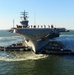 The aircraft carrier USS Dwight D. Eisenhower (CVN 69) makes its approach pierside at Naval Station Norfolk after a six-month deployment to the U.S. 5th and 6th Fleet areas of responsibility in support of Operation Enduring Freedom, maritime security oper