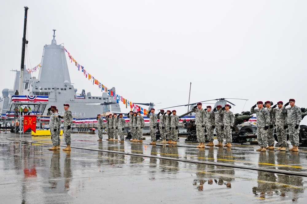 Airborne artillerymen salute USS Anchorage