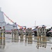 Airborne artillerymen salute USS Anchorage