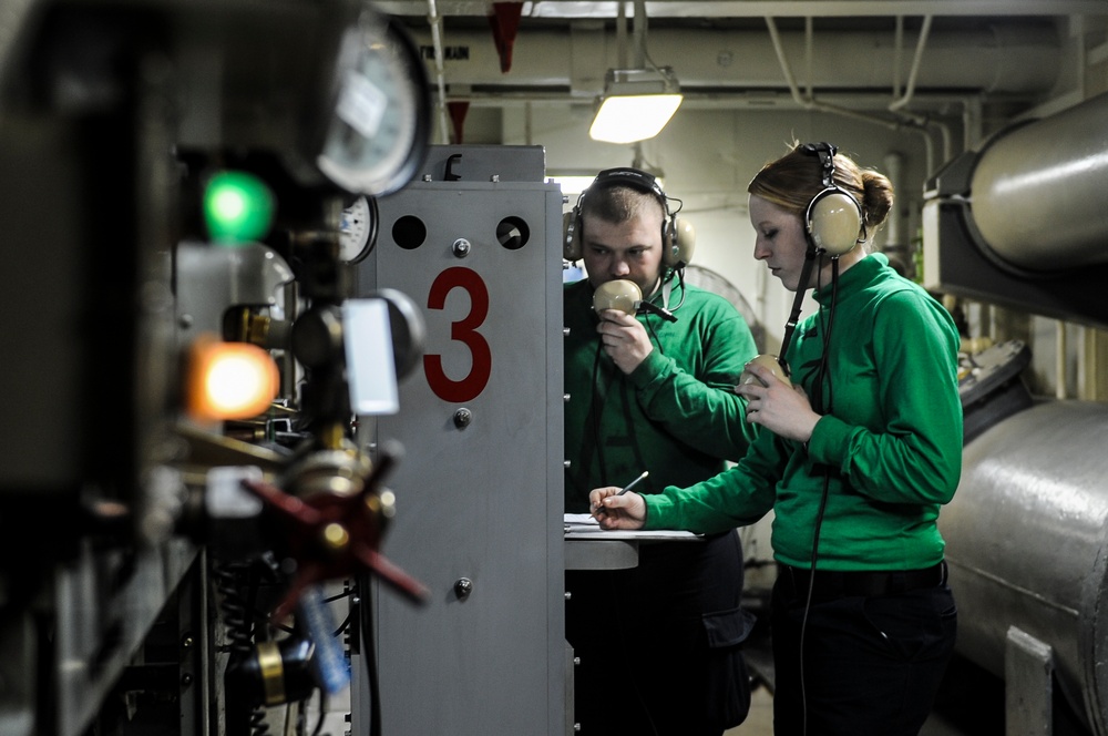 USS Nimitz sailors at work in arresting gear room