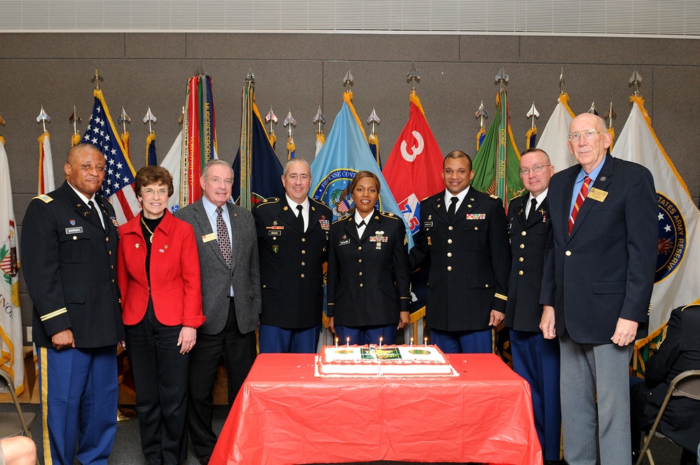 Oldest and youngest soldiers with distinguished visitors pose before the cake cutting