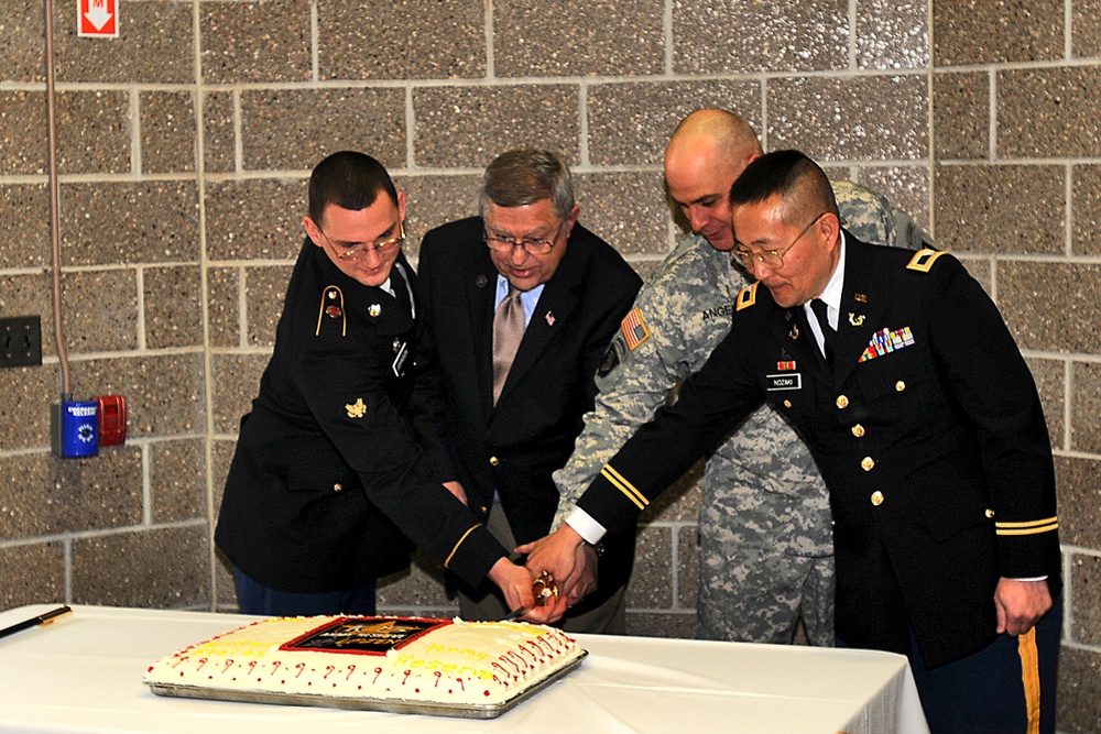 Oldest and youngest with Army Reserve ambassador cut the cake