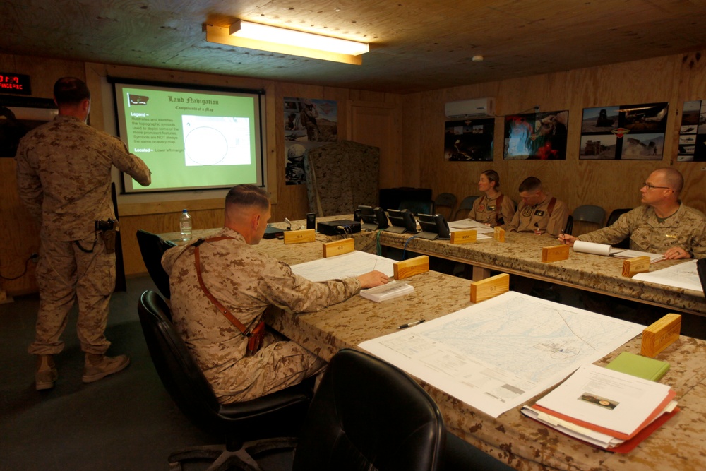 U.S. Navy Sailors work towards their Fleet Marine Force badge with the help of U.S. Marines