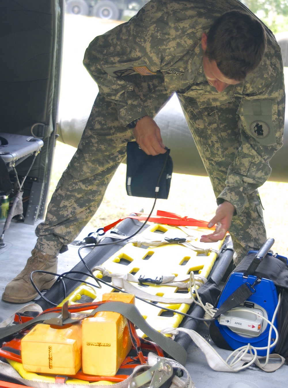 Sgt. Trevor Hogan prepares the UH-60 Black Hawk for a mock medevac scenario during a training exercise as a part of Beyond the Horizon - El Salvador 2013