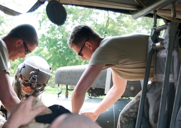 The ground medic team loads the casualty into the UH-60 Black Hawk for a mock medevac scenario during a training exercise