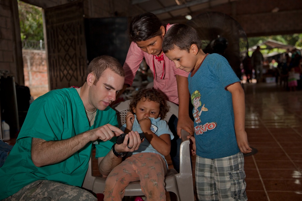 U.S. Army Cadet Matthew Lisle interacts with local children in Metalio, El Salavador