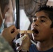 Soldier conducts dental screening in Metalio, El Salador