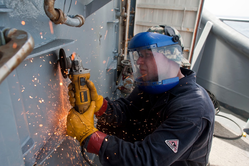 USS Hue City sailor at work