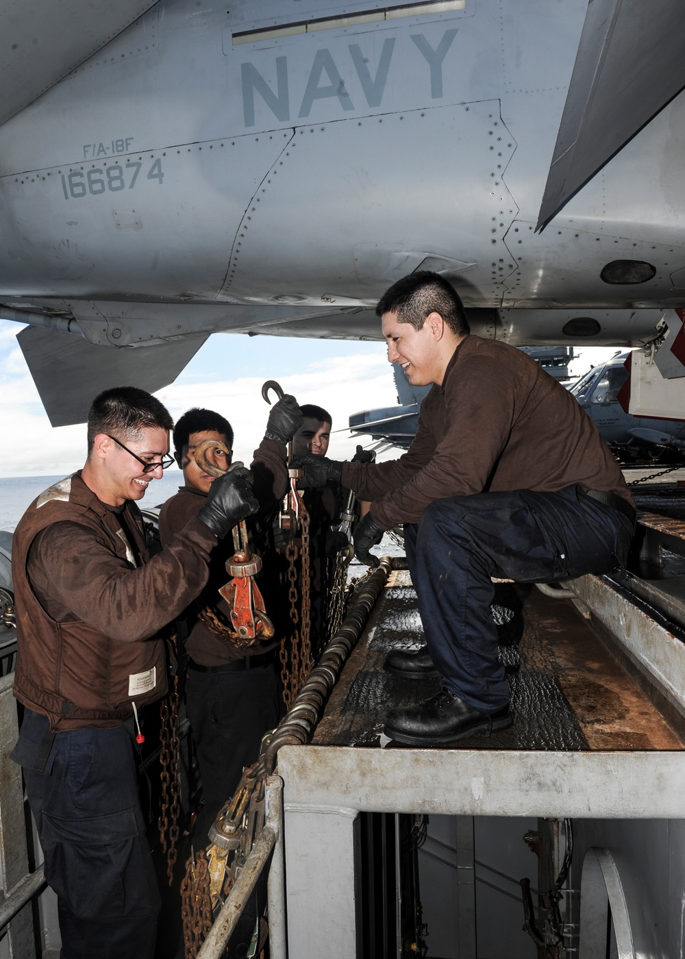 USS Nimitz sailors stow chain