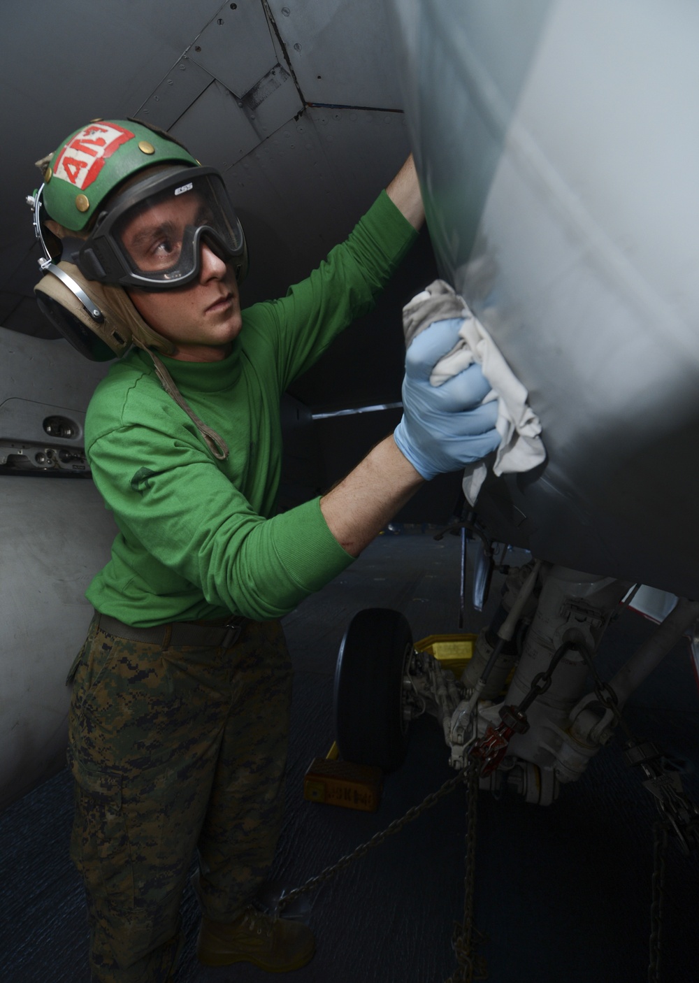 Nimitz sailor polishes aircraft