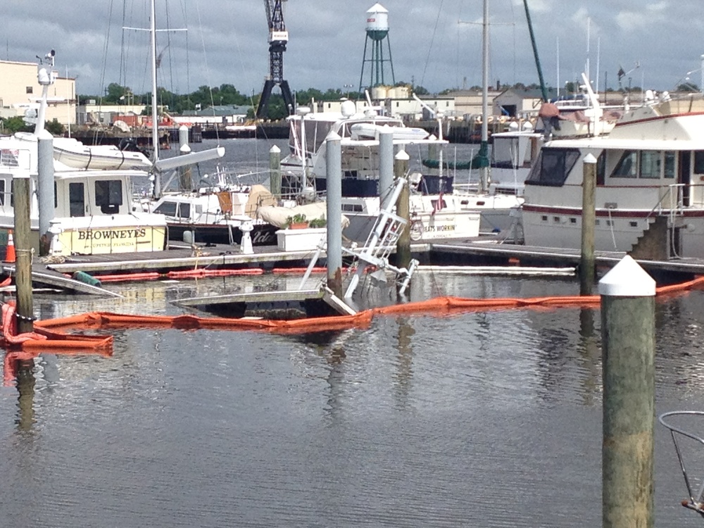 Boom surrounds a sunken boat