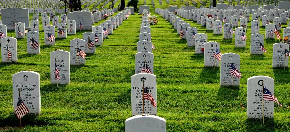 Old Guard soldiers plant flags at Arlington National Cemetery