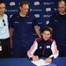 Revolution's coach Jay Heaps signs a document of support with the U.S. Coast Guard