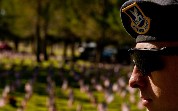 Airmen place flags at the Southern Nevada Veterans Memorial Cemetery