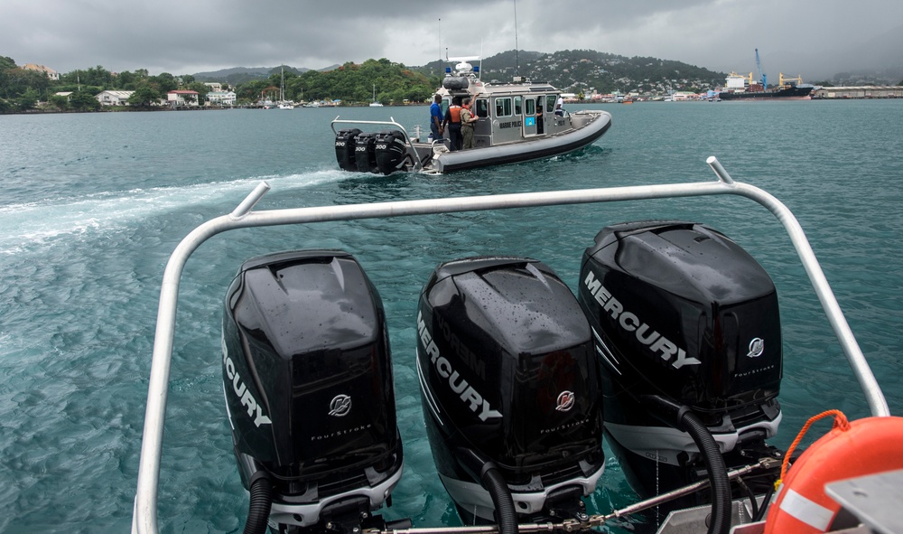 A Saint Lucian Coast Guard Interceptor boat crosses the stern of another Interceptor near the port of Castries