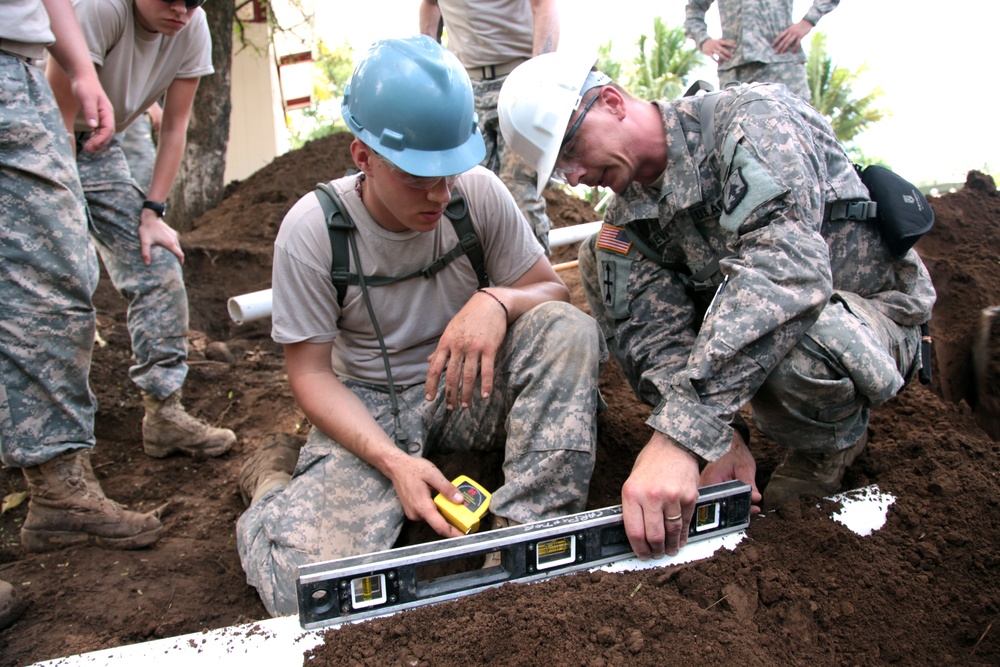 Joint Task Force Jaguar soldiers build latrine for school