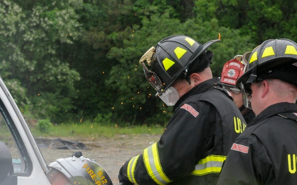 National Guard firefighters learn to rescue victims of auto accidents at local car parts lot