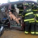 National Guard firefighters learn to rescue victims of auto accidents at local car parts lot