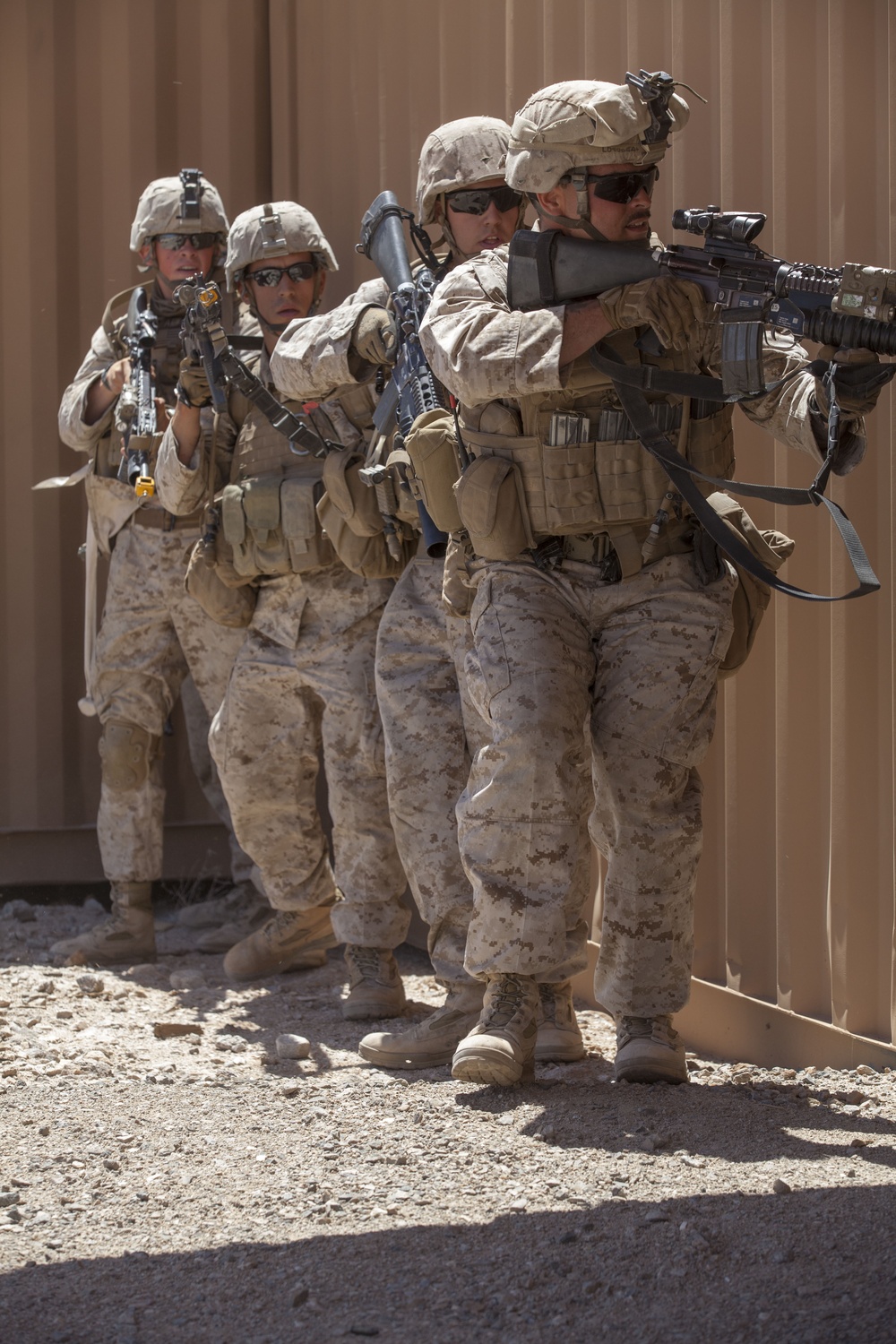 Fire team of Marines with 3rd Battalion, 1st Marines, based out of Camp Pendleton, Calif., stack up to assault the makeshift mosque within the combat village at the Western Barry M. Goldwater Range Yuma, Ariz., June 3.