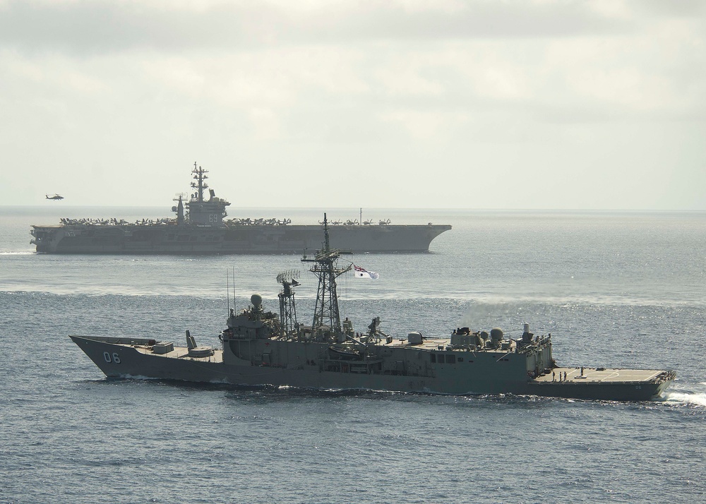 HMAS Newcastle transits alongside USS Dwight D. Eisenhower
