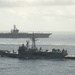 HMAS Newcastle transits alongside USS Dwight D. Eisenhower