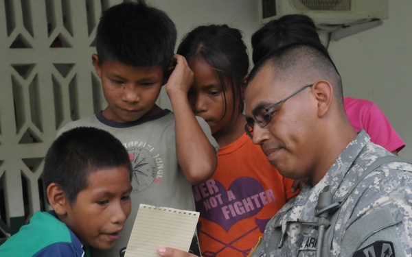 Service member at end of road providing medical care to Panamanians