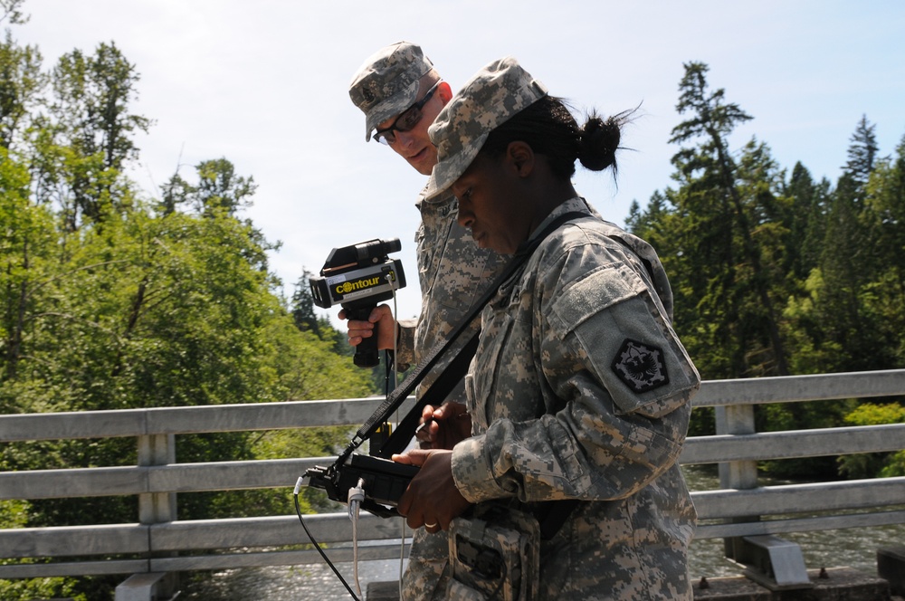 Soldiers training on the ENFIRE system, which is a digital reconnaissance and surveying equipment instrument set.
