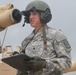 Spc. Corey M. Locker bore sights the main weapon system of an M1A1 Abrams tank