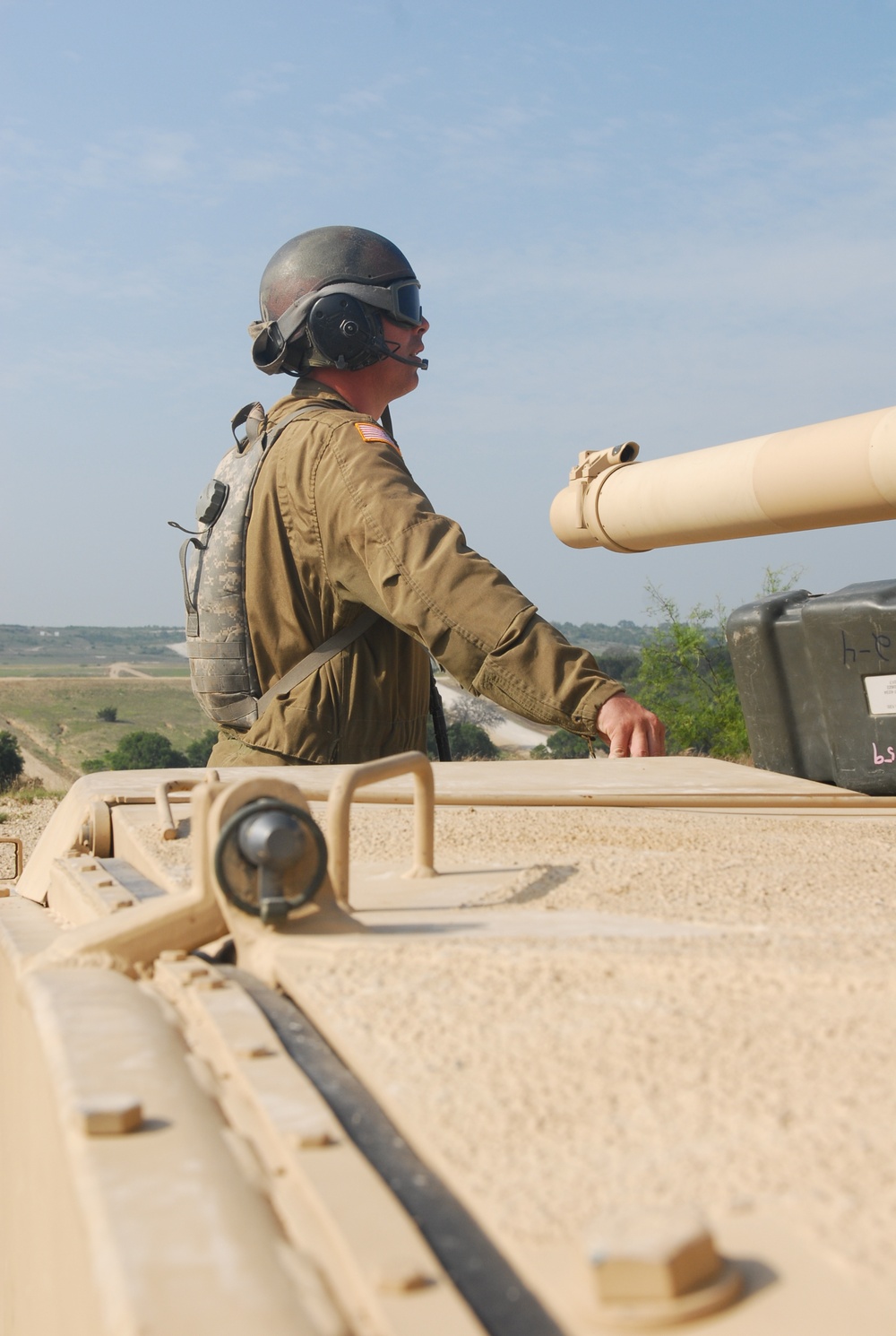 Sgt. 1st Class Daniel Fortney, a platoon sergeant with Charlie Company, 1-145th Armored Regiment, assists in bore sighting the weapon systems of an M1A1 Abrams tank