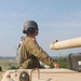 Sgt. 1st Class Daniel Fortney, a platoon sergeant with Charlie Company, 1-145th Armored Regiment, assists in bore sighting the weapon systems of an M1A1 Abrams tank