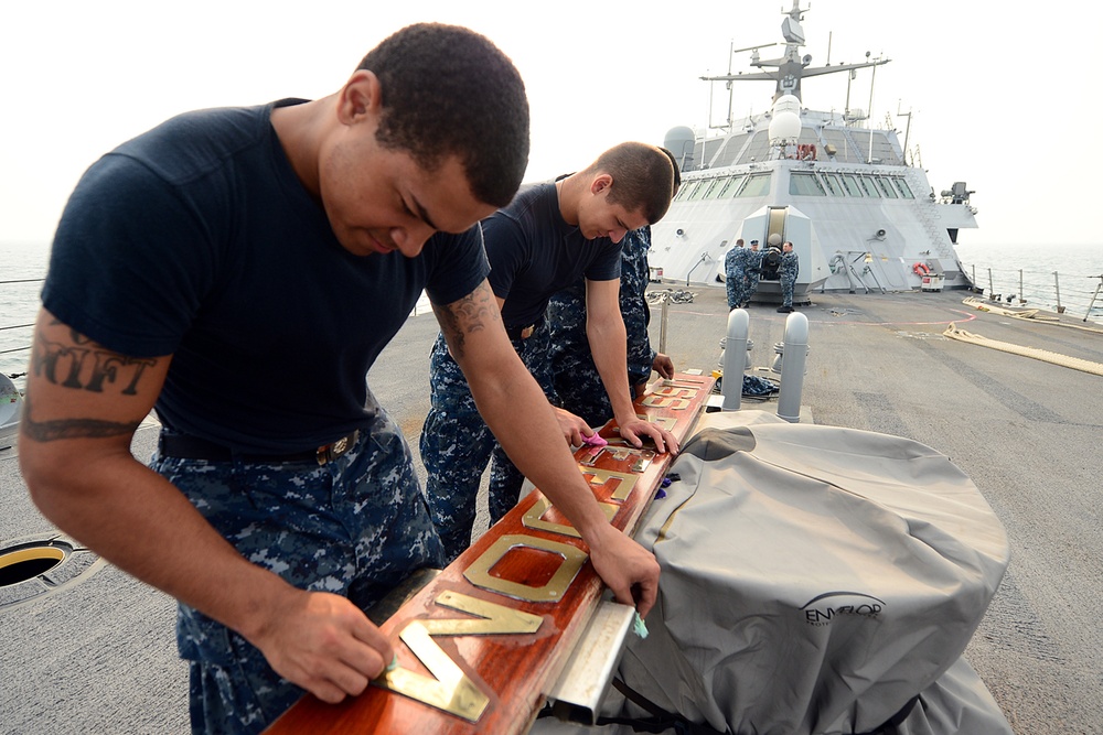 USS Freedom sailors polish sign