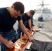 USS Freedom sailors polish sign