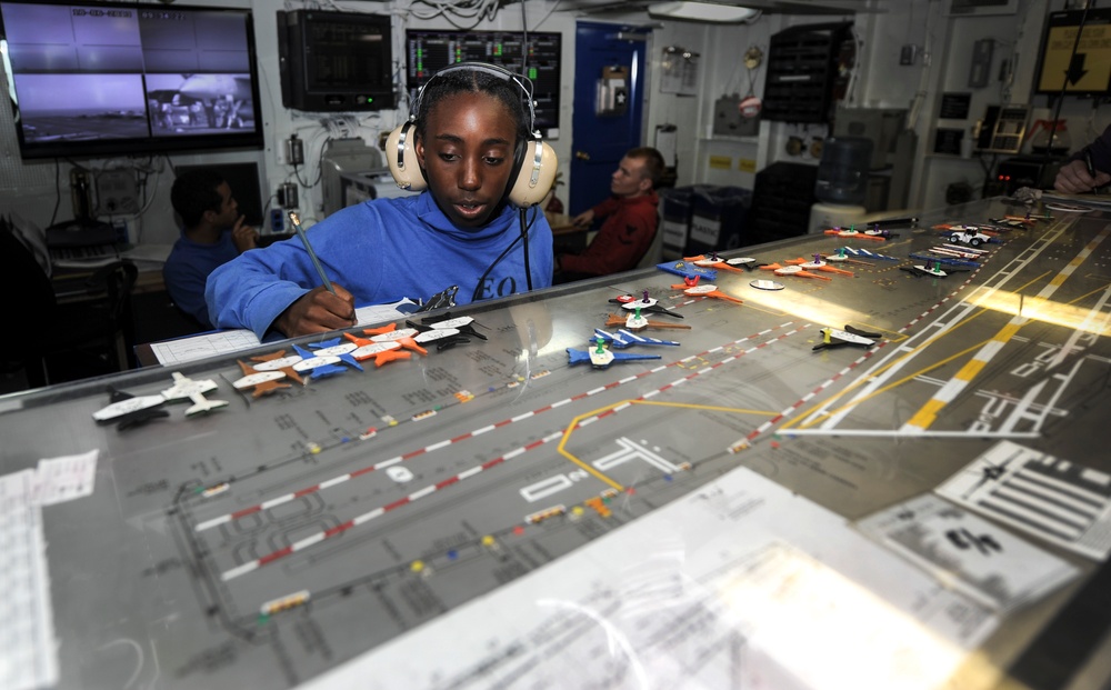 Sailor makes adjustments to flight deck control