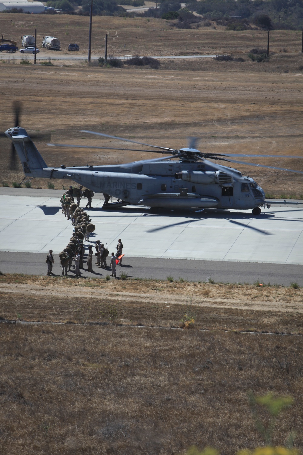 Marines board aircraft for an air assault training exercise for Dawn Blitz 2013