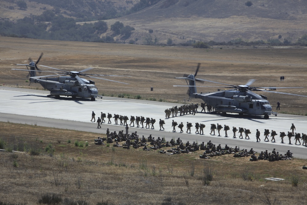 Marines board aircraft for an air assault training exercise for Dawn Blitz 2013