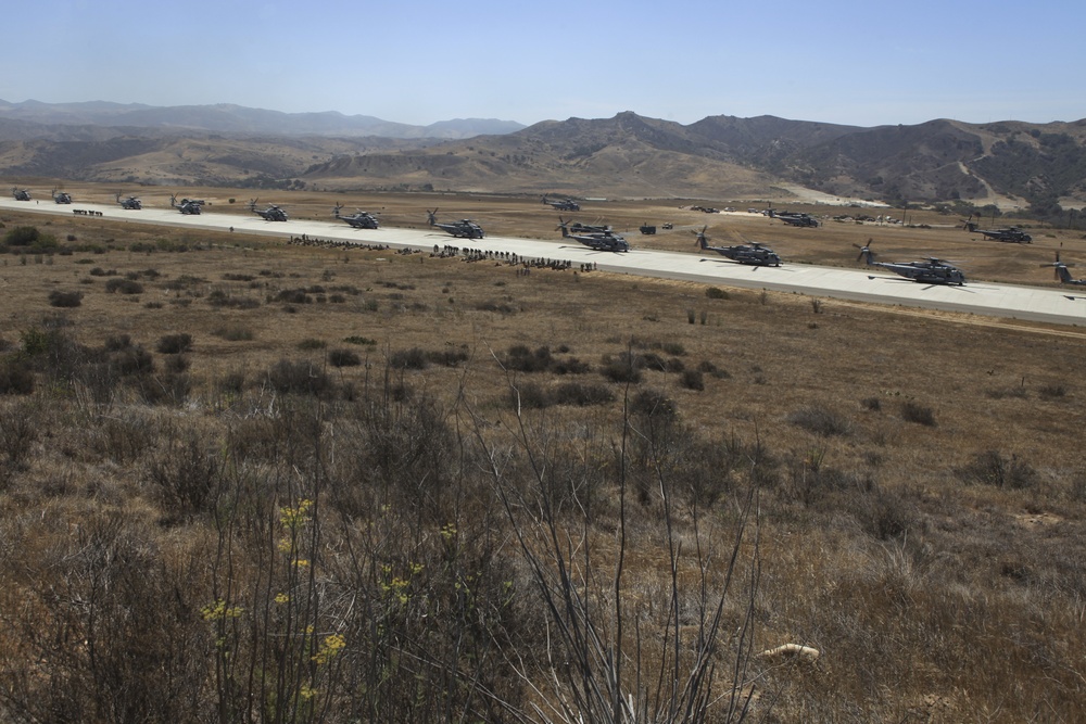 Marines board aircraft for an air assault training exercise for Dawn Blitz 2013