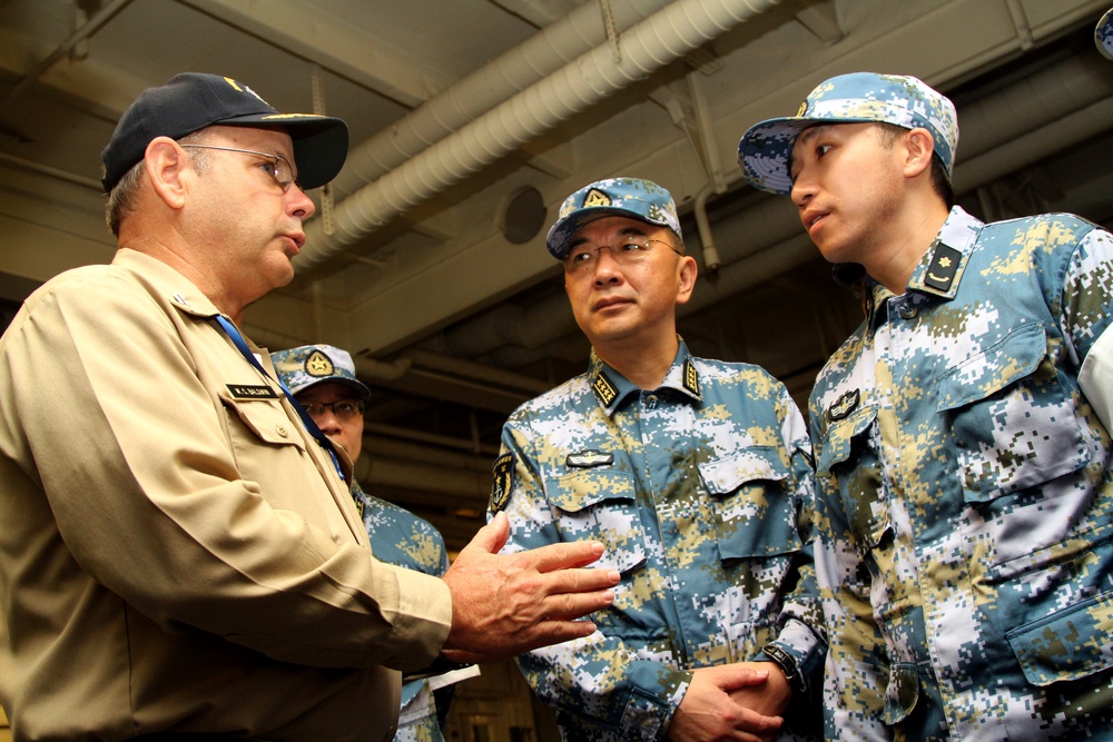China board US Navy Ship
