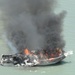 A fishing boat burns after CBP rescues 2